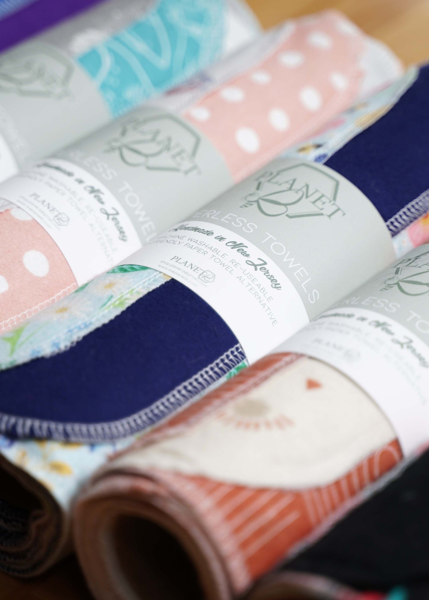 Rolls of various printed paperless towels laid out next to each other